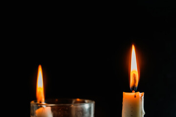 Cozy candle flames dancing in the darkness create a peaceful ambiance for reflection and remembrance