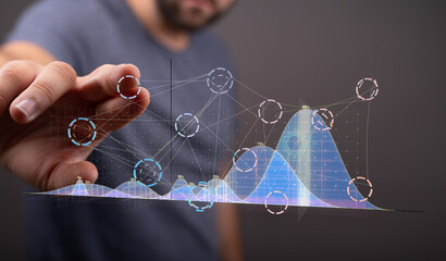 Person analyzing financial data using futuristic interface.  Stock photo for technology, finance, analytics.