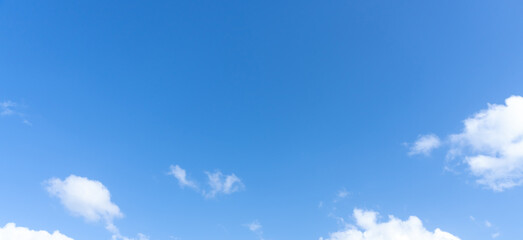Low angle view and full frame of beautiful blue sky with strange shape of fluffy white clouds in the afternoon on sunny day used as natural background texture in decorative art work