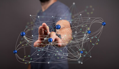 Image of a person interacting with a complex network visualization, representing connections and data flow.