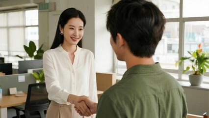 Business people shaking hands, finishing up a meeting. Asian businesswoman and businessman shaking hands in office.