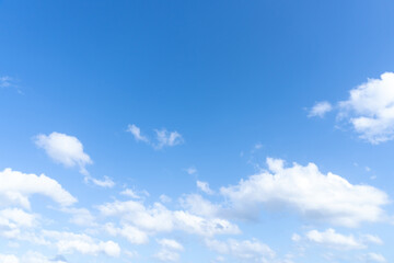 Low angle view and full frame of beautiful blue sky with strange shape of fluffy white clouds in the afternoon on sunny day used as natural background texture in decorative art work