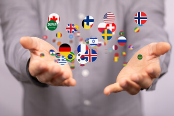 Image of hands holding diverse country flags, symbolizing international business and global reach.