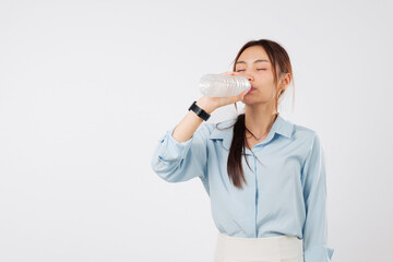 Young woman drink bottle water hold eyes closed, asian girl enjoying her refreshing drink from a plastic bottle for hydration, smiling and positive, isolated studio white background