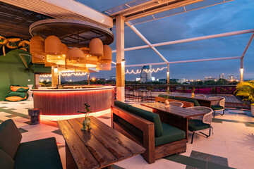 Contemporary roof top bar and cityscape view at twilight.