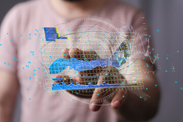 Close-up of a person interacting with a holographic display showing dynamic data charts and graphs.