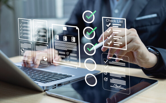 Business performance tracking and evaluation concept. Personnel using laptops and tablets to complete online checklists with checkboxes. Digital survey and assessment tools.