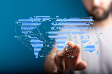 Hand pointing at a digital world map illustrating global network and connection.