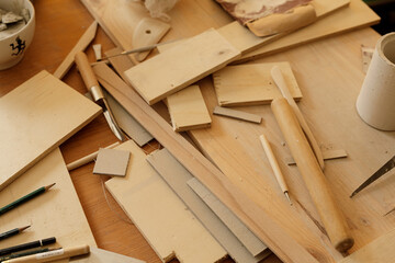 Close-up of various woodworking tools and materials on a work surface.  Ideal for DIY, crafting, and hobby projects.