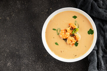 Tom kha soup shrimp, coconut milk, miso paste tasty seafood snack fresh delicious gourmet food background on the table rustic food top view copy space pescetarian diet