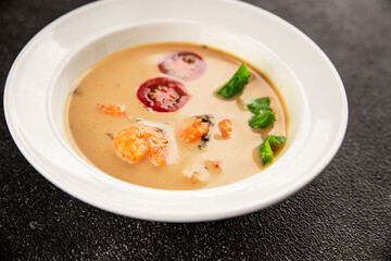 Tom kha soup shrimp, coconut milk, miso paste tasty seafood snack fresh delicious gourmet food background on the table rustic food top view copy space pescetarian diet
