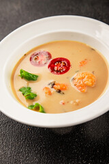Tom kha soup shrimp, coconut milk, miso paste tasty seafood snack fresh delicious gourmet food background on the table rustic food top view copy space pescetarian diet