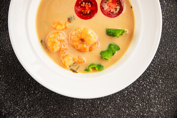 Tom kha soup shrimp, coconut milk, miso paste tasty seafood snack fresh delicious gourmet food background on the table rustic food top view copy space pescetarian diet