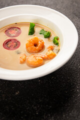 Tom kha soup shrimp, coconut milk, miso paste tasty seafood snack fresh delicious gourmet food background on the table rustic food top view copy space pescetarian diet