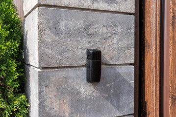 Gate post with black photocell sensor for automatic gates