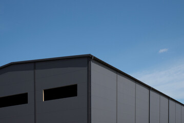 Industrial metal panel building facade under blue sky