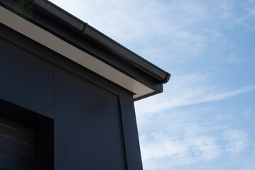 PVC rain gutter at eaves with soffit and fascia