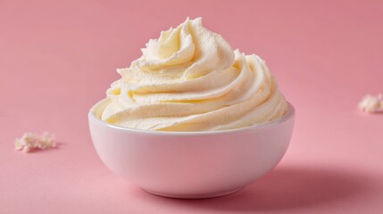 A 4K photo of creamy whipped butter in a bowl contrasts beautifully with a soft pink backdrop.