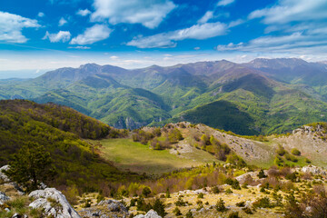 Dramatic scenery with clouds and lush green flora in the Carpathians Mountains in spring
