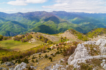 Dramatic scenery with clouds and lush green flora in the Carpathians Mountains in spring