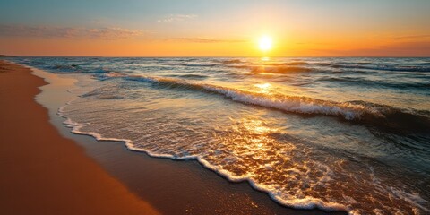 Obraz premium peaceful beach and ocean at golden sunset