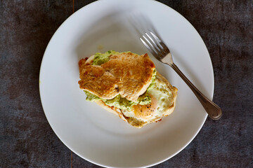 fried egg and avocado stuffed chicken breast