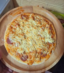 Delicious fresh baked Italian pizza with ham and mozzarella cheese on a plate, isolated on a white background