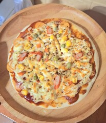 Delicious fresh baked Italian pizza with ham and mozzarella cheese on a plate, isolated on a white background