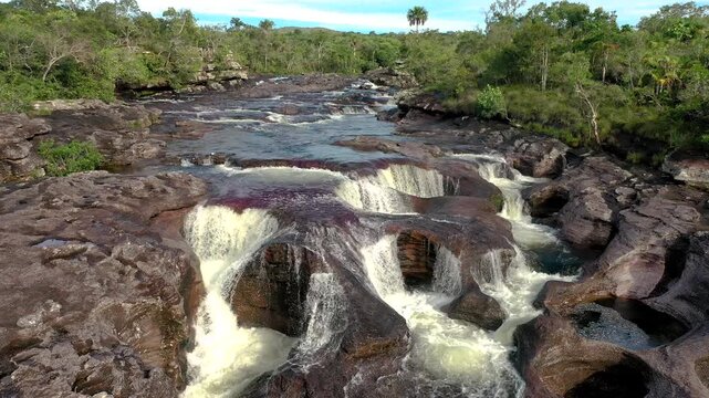 Waters cascading through rocky formations in Colombia Cano Cristales River