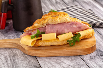 Fresh croissant with ham and cheese