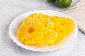 Sweet canned pineapple slices in syrope