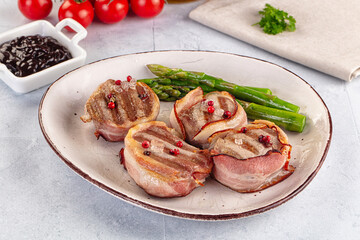 Tasty grilled pork medallion with bacon