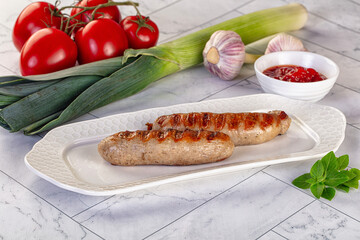 Grilled pork sausages served tomato sauce
