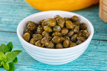Pickled canned capers in the bowl