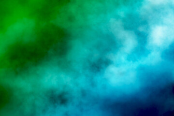 Green and blue mixing smoke creating abstract background texture