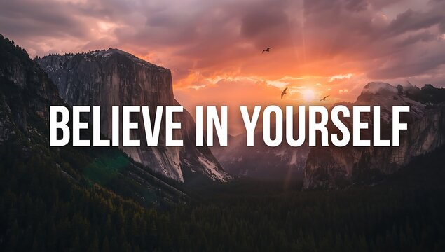 Believe in yourself text overlayed on a mountain landscape at sunset with birds flying above