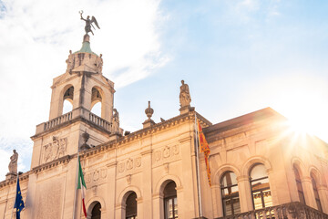 Obraz premium Ornate facade of Palazzo Moroni, the town hall of Padova, Italy, against blue sky in summer, with Italian and EU flags
