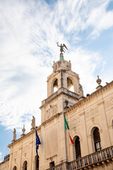 Fototapeta premium Ornate facade of Palazzo Moroni, the town hall of Padova, Italy, against blue sky in summer, with Italian and EU flags