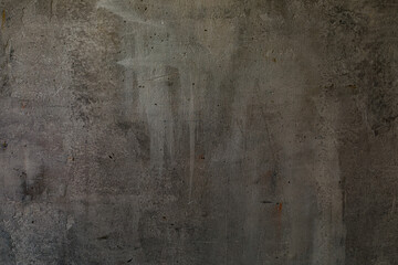 Decorative shabby dark-grey plastered wall with scratches, art background, copy space.