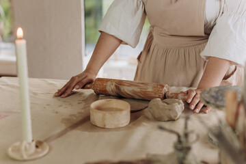 Clay modeling. Pottery. Woman kneading clay