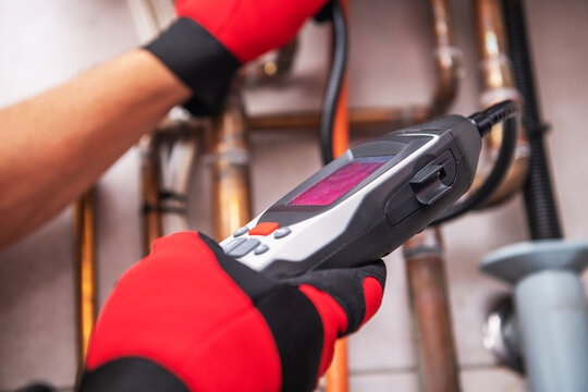 Technician Uses Advanced Device to Inspect Natural Gas Systems at Facility