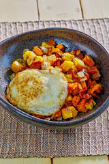 sweet potato and plantain hash topped with a fried egg