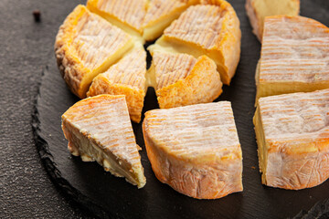 Cheese plate camembert, brie, munster french cheese tasty snack fresh delicious gourmet food background on the table rustic food top view copy space