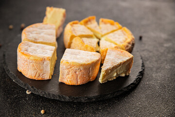 Cheese plate camembert, brie, munster french cheese tasty snack fresh delicious gourmet food background on the table rustic food top view copy space