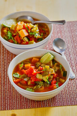 vegetable stew with zucchini, sweet potato, and kale in a tomato broth