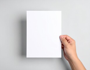 Obraz premium Blank A4 White Paper Mockup Held by Hand: Clean Background. Simplicity, Professionalism & Document Display