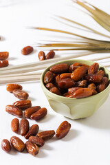 Fresh Organic Dates in Green Bowl with Palm Leaves