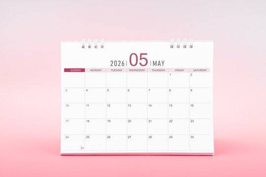 May blank desk calendar for 2026 year on pink color background.