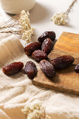 Fresh Medjool Dates on Wooden Board and Linen Cloth