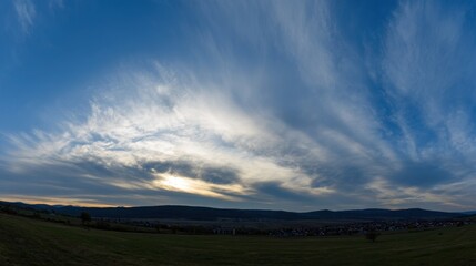 Fototapeta premium Dramatic sunrise and sunset sky with vibrant clouds, showcasing warm and cool color contrasts in a panoramic view.